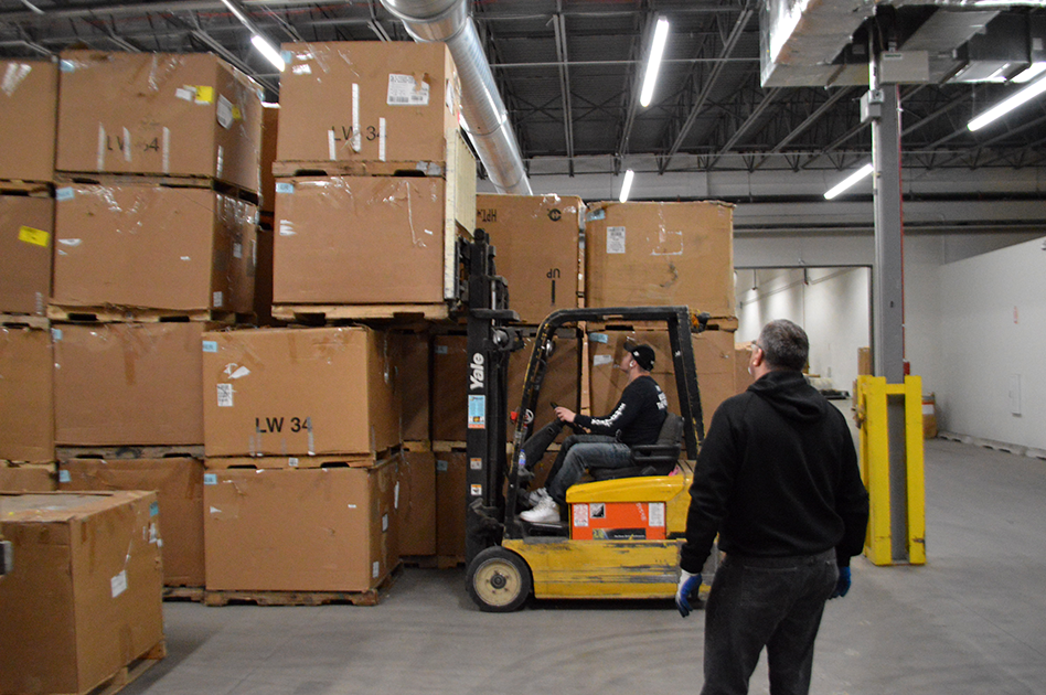 John Hasstedt observes Kaleb operating a forklift.