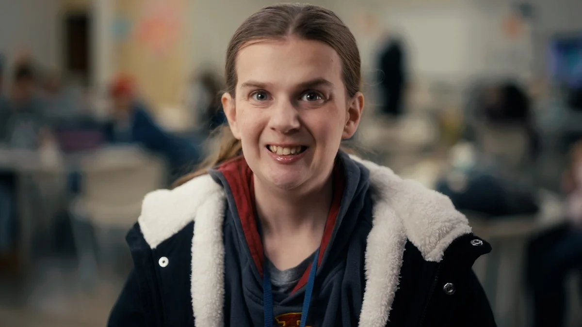 woman in a black coat smiles at camera