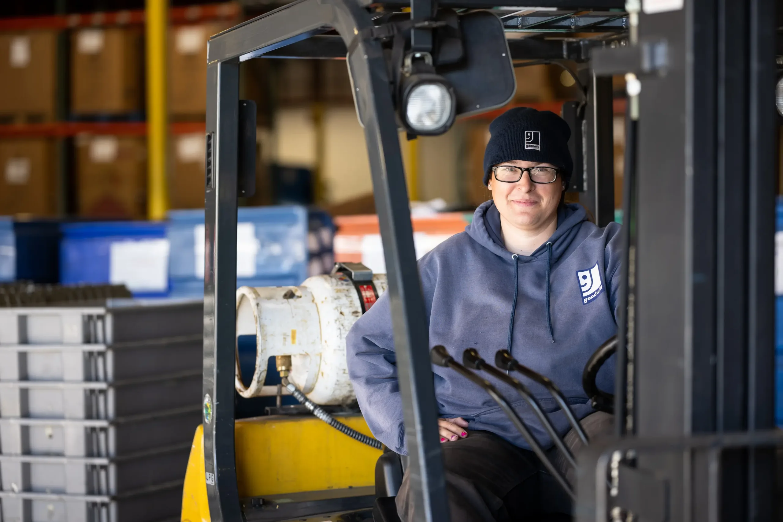 Eighth_20221103_GII_0700 employee posing behind the window of equipment