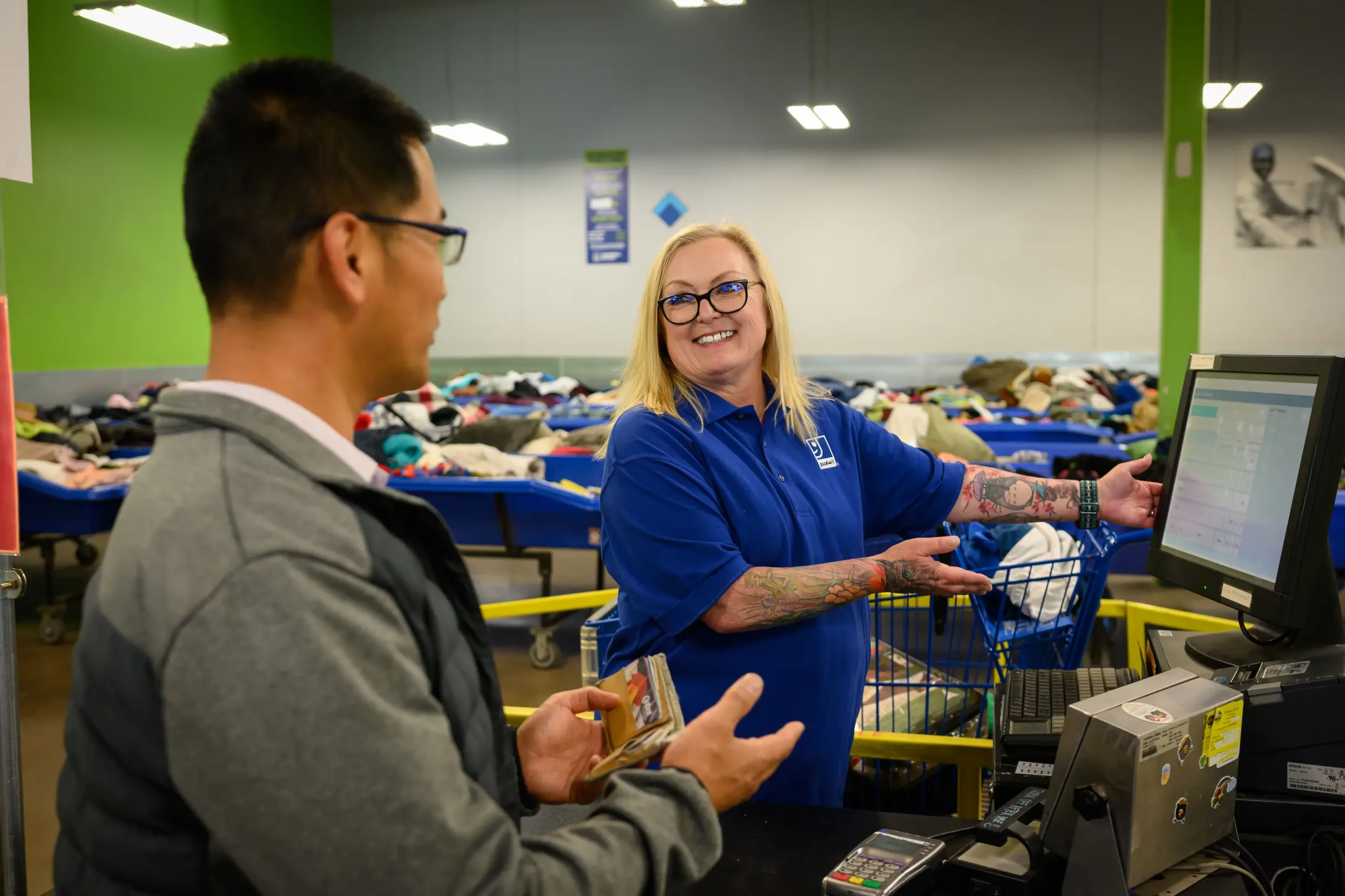 Seventh_20230919-DSC_4393 employees referencing a computer display